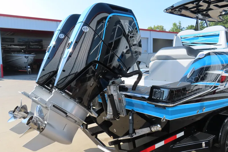 Slide: The Image of 2024 Sunsation 32CCX boat with dual outboard engines, blue and black design, docked outdoors. - 17