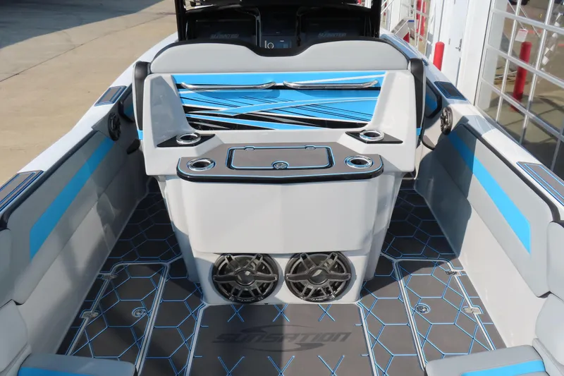 Slide: The Image of 2024 Sunsation 32CCX boat interior with blue accents and modern seating design. - 4