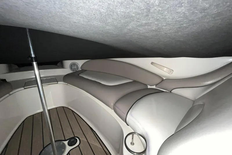 Slide: The Image of Interior seating of 2002 Sea Ray 270 Sundeck boat with cushioned seats and wooden flooring. - 10
