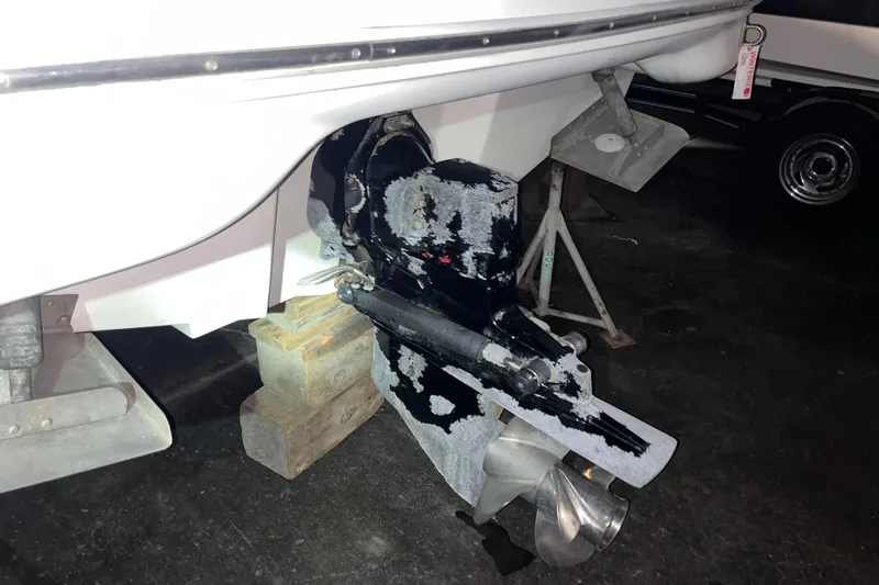Slide: The Image of 2002 Sea Ray 270 Sundeck boat outdrive on blocks in a garage. - 12