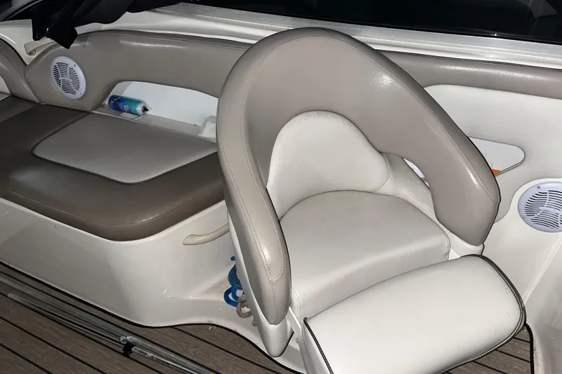 Slide: The Image of Interior seating of a 2002 Sea Ray 270 Sundeck boat with beige upholstery. - 8