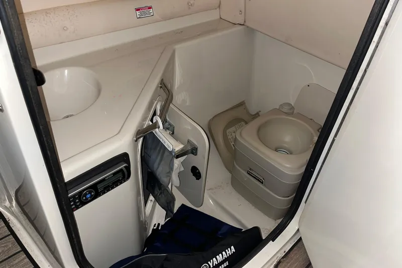 Slide: The Image of 2002 Sea Ray 270 Sundeck boat interior with compact bathroom amenities. - 9