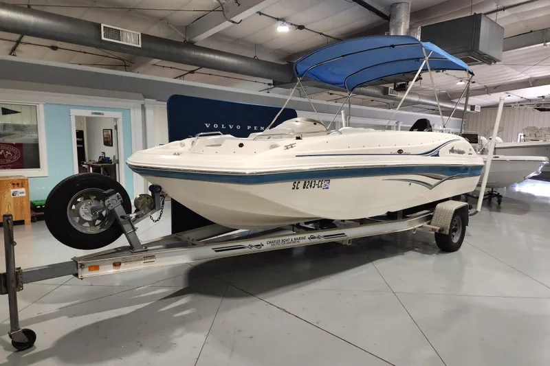 Slide: The Image of 2007 Hurricane FunDeck GS 194 OB interior with white and blue seating, spacious layout. - 17