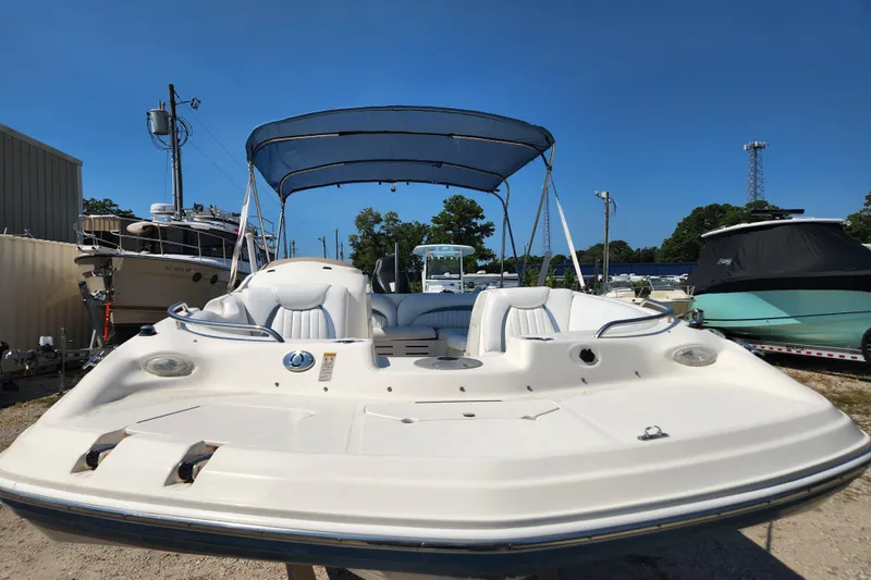 Slide: The Image of 2007 Hurricane FunDeck GS 194 OB boat with blue canopy on trailer in showroom. - 4