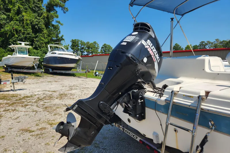 Slide: The Image of 2007 Hurricane FunDeck GS 194 O/B boat with outboard motor and canopy, parked on gravel. - 6