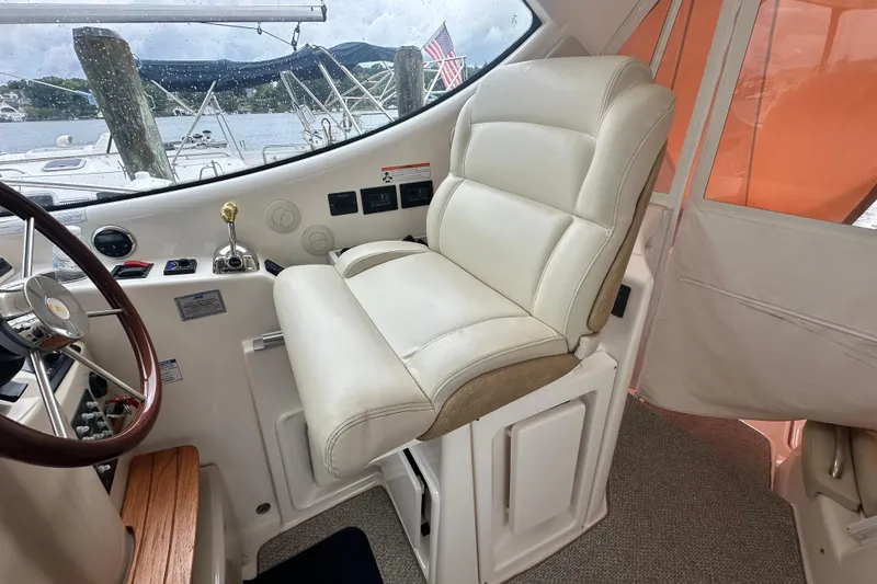 Slide: The Image of 2007 Tiara Yachts 3900 Sovran helm with luxurious white captain's chair and steering wheel. - 10
