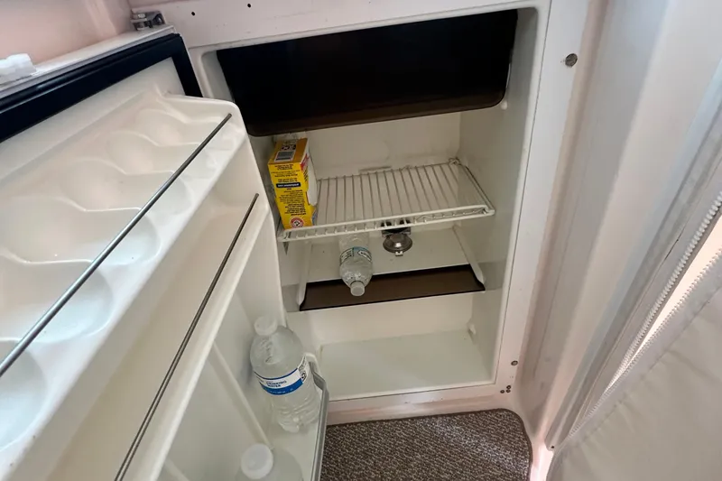 Slide: The Image of Open fridge in 2007 Tiara Yachts 3900 Sovran with water bottles and baking soda. - 13