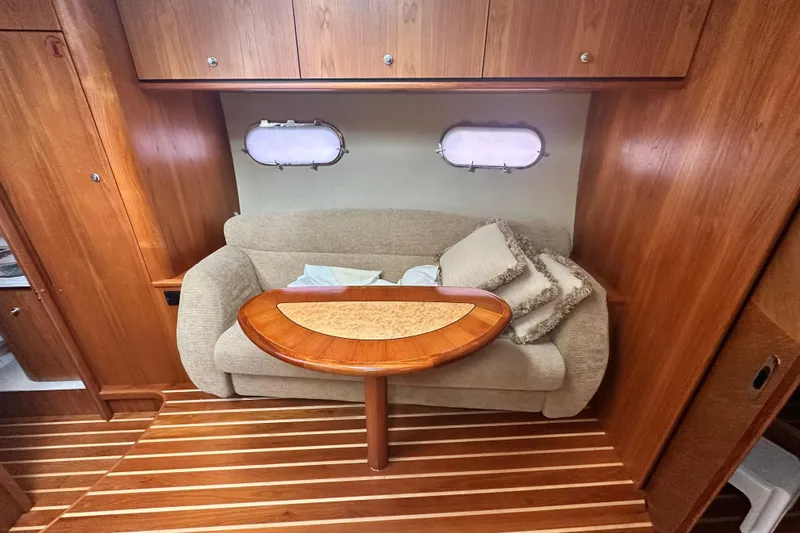 Slide: The Image of 2007 Tiara Yachts 3900 Sovran interior with cozy seating and elegant wooden table. - 22