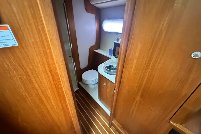 Slide: The Image of 2007 Tiara Yachts 3900 Sovran bathroom with wooden cabinetry and modern fixtures. - 24