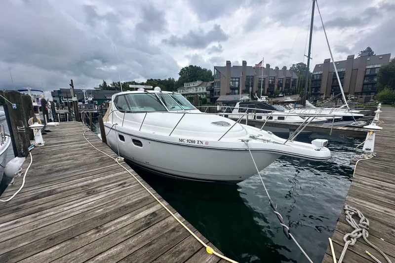 Slide: The Image of 2007 Tiara Yachts 3900 Sovran docked at a marina under cloudy skies. - 3