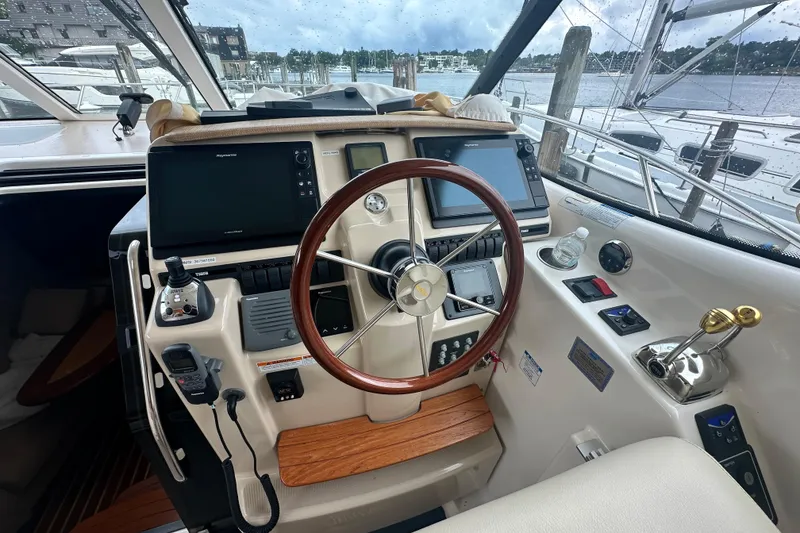 Slide: The Image of 2007 Tiara Yachts 3900 Sovran helm with wooden steering wheel and modern navigation equipment. - 6
