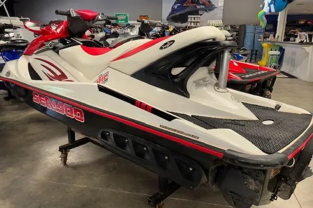 Slide: The Image of 2006 Sea-Doo Wake jet ski in showroom, featuring red and white design. - 5