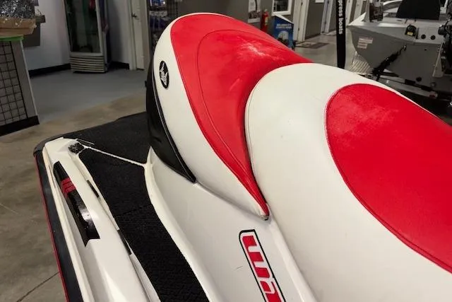 Slide: The Image of 2006 Sea-Doo Wake jet ski with red and white seat in showroom. - 9