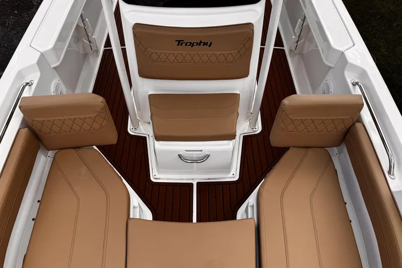 Slide: The Image of 2023 Bayliner Trophy T20CC boat interior with tan seating and wood-style flooring. - 12