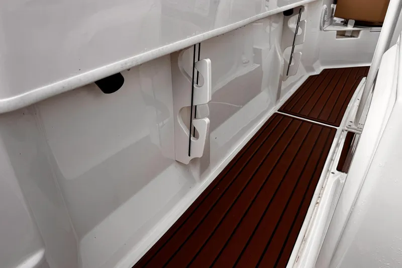 Slide: The Image of 2023 Bayliner Trophy T20CC interior with sleek white design and wood-style flooring. - 20