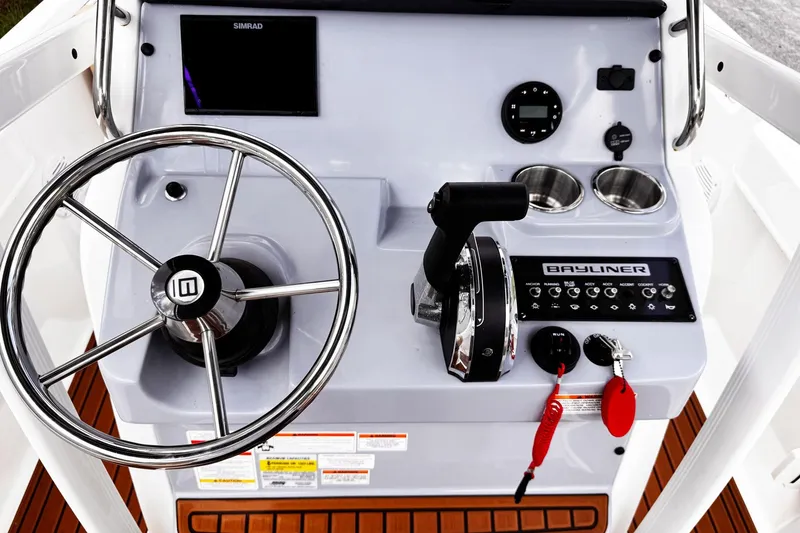 Slide: The Image of 2023 Bayliner Trophy T20CC boat console with steering wheel and controls. - 7