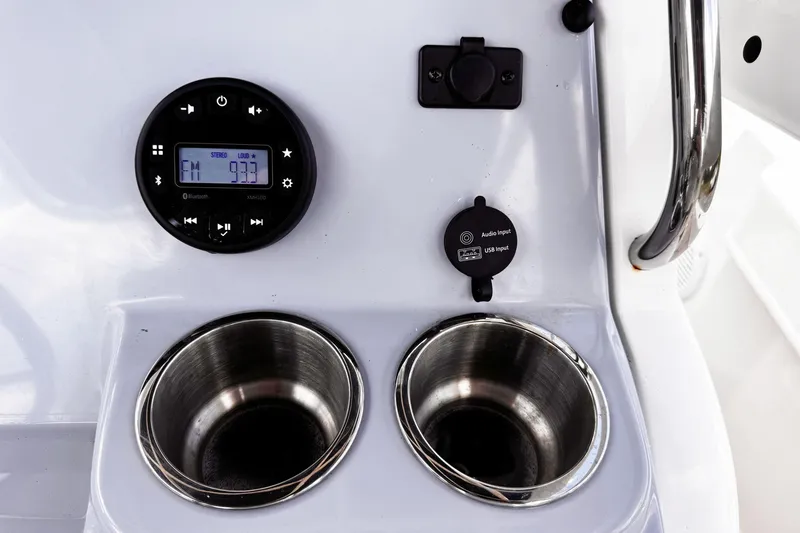 Slide: The Image of 2023 Bayliner Trophy T20CC dashboard with stereo, cup holders, and USB input. - 9