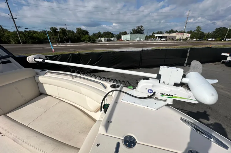 Slide: The Image of 2016 Grady-White Freedom 275 boat on blue water near a large bridge. - 112