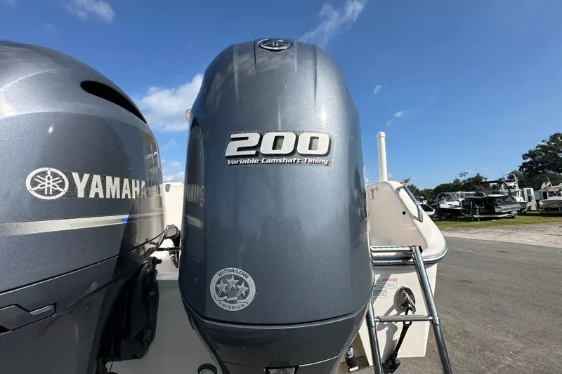 Slide: The Image of 2016 Grady-White Freedom 275 boat on trailer under clear blue sky. - 12