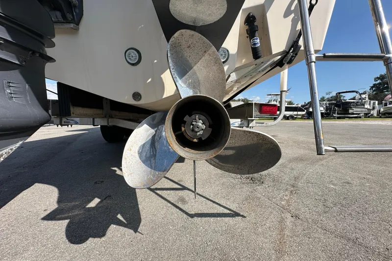 Slide: The Image of 2016 Grady-White Freedom 275 boat front view with anchor, clear sky background. - 13