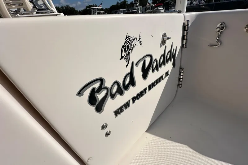 Slide: The Image of 2016 Grady-White Freedom 275 boat interior at a sale event, showcasing seating and storage. - 18