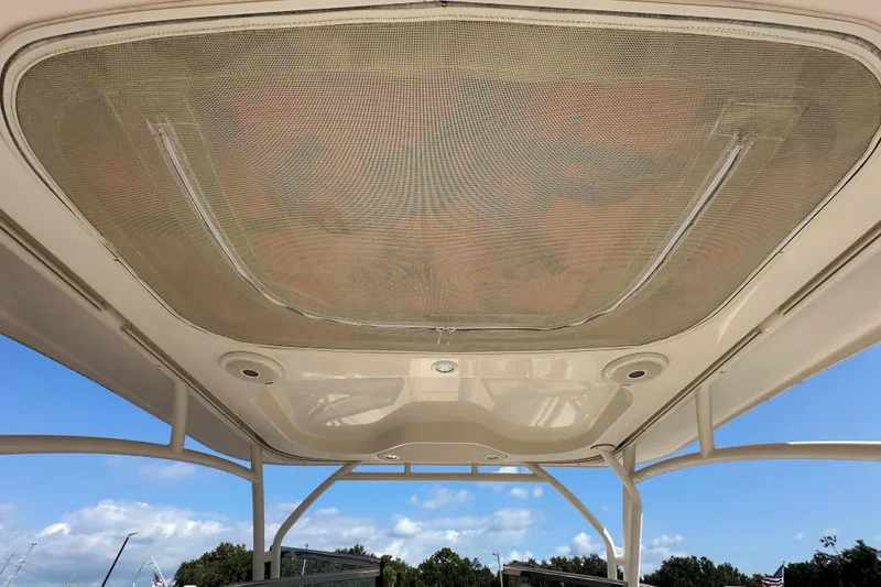 Slide: The Image of 2016 Grady-White Freedom 275 boat interior with beige seating and shadow. - 22