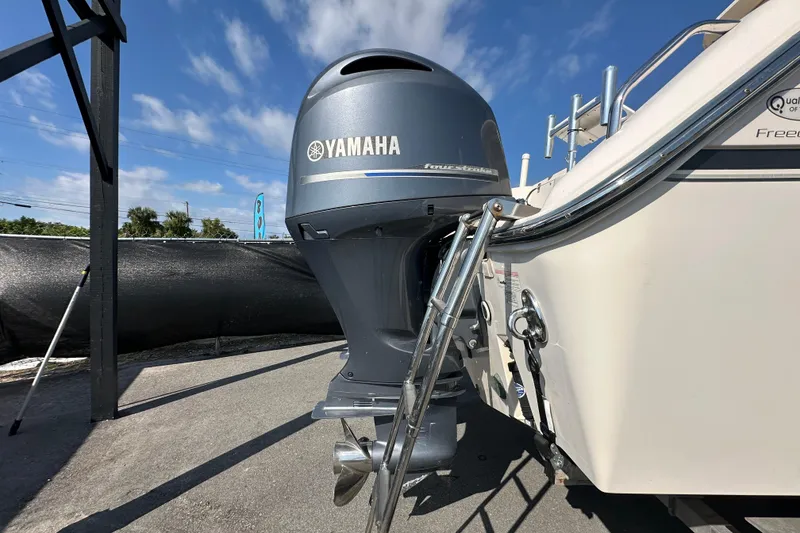 Slide: The Image of 2016 Grady-White Freedom 275 boat on trailer under clear blue sky. - 3