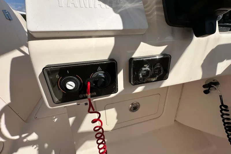 Slide: The Image of 2016 Grady-White Freedom 275 dashboard with Garmin display showing trip data and controls. - 30