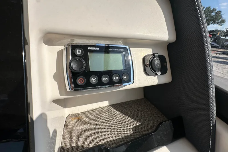 Slide: The Image of Control panel of a 2016 Grady-White Freedom 275 boat with switches and dials. - 32