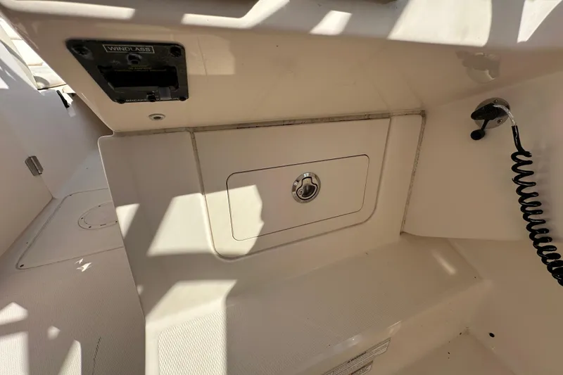 Slide: The Image of 2016 Grady-White Freedom 275 boat interior with compact marine toilet and wooden flooring. - 38