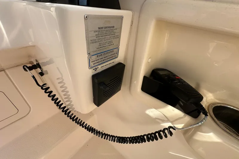 Slide: The Image of 2016 Grady-White Freedom 275 boat cockpit with steering wheel and navigation display. - 40