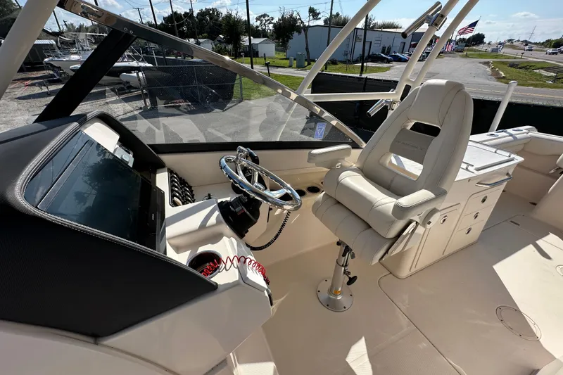 Slide: The Image of 2016 Grady-White Freedom 275 boat interior, featuring seating and storage compartments. - 41