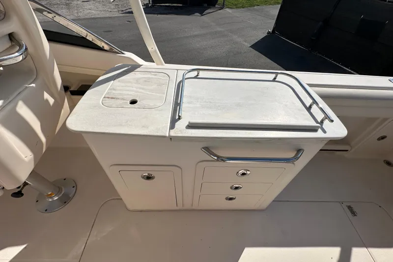 Slide: The Image of 2016 Grady-White Freedom 275 boat interior with white seating and spacious layout. - 45