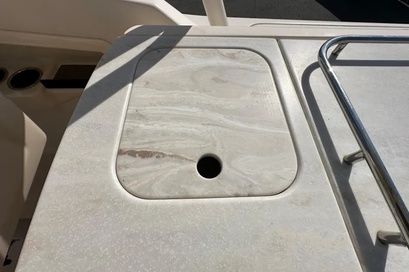 Slide: The Image of 2016 Grady-White Freedom 275 boat interior with white cushioned seating. - 46