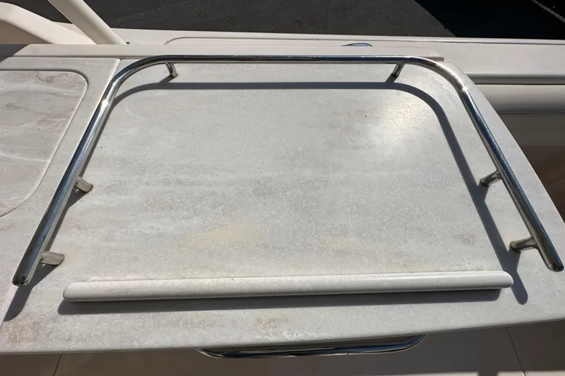 Slide: The Image of 2016 Grady-White Freedom 275 boat storage compartment with open lid, showcasing interior space. - 48