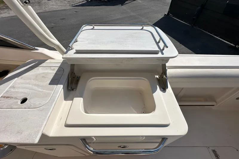 Slide: The Image of 2016 Grady-White Freedom 275 boat interior with storage compartments open. - 49