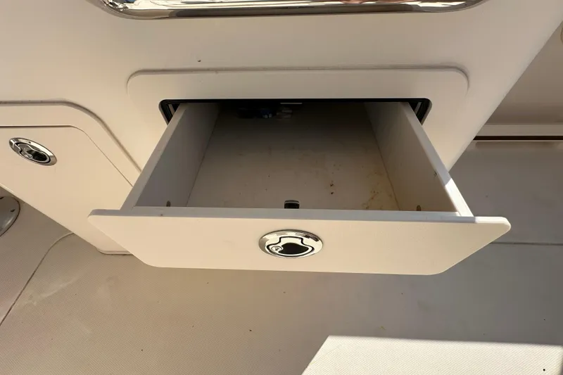 Slide: The Image of 2016 Grady-White Freedom 275 boat deck with open storage compartment. - 52