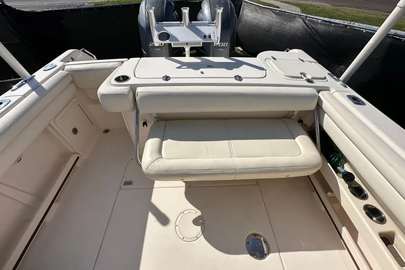 Slide: The Image of 2016 Grady-White Freedom 275 boat interior with seating and steering wheel. - 61