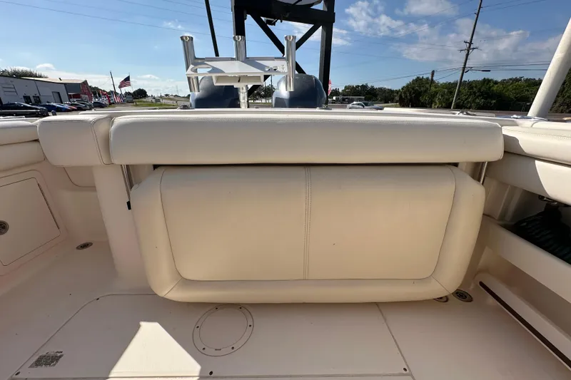 Slide: The Image of 2016 Grady-White Freedom 275 boat interior with cushioned seating and storage compartments. - 64