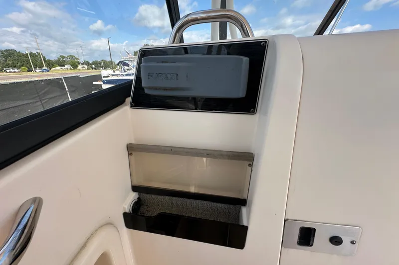 Slide: The Image of Trailer wheels of a 2016 Grady-White Freedom 275 boat on pavement. - 75