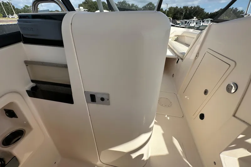 Slide: The Image of 2016 Grady-White Freedom 275 warning label about carbon monoxide and propeller safety. - 77