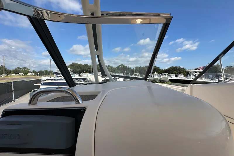 Slide: The Image of 2016 Grady-White Freedom 275 boat interior with white seating and open cockpit view. - 83