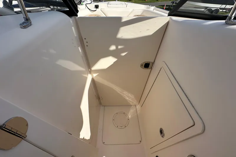 Slide: The Image of 2016 Grady-White Freedom 275 boat interior with seating and steering wheel, parked outdoors. - 86