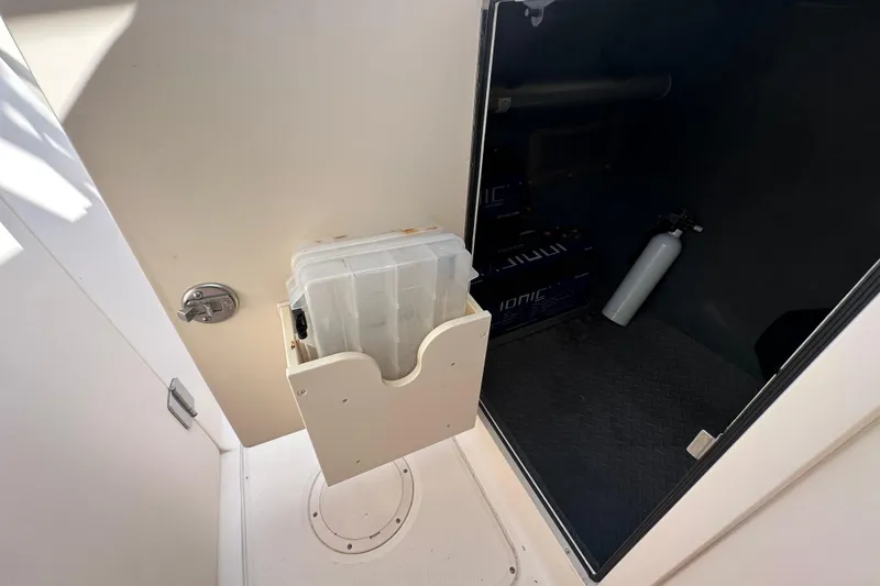 Slide: The Image of 2016 Grady-White Freedom 275 boat interior with white seating and helm station. - 88