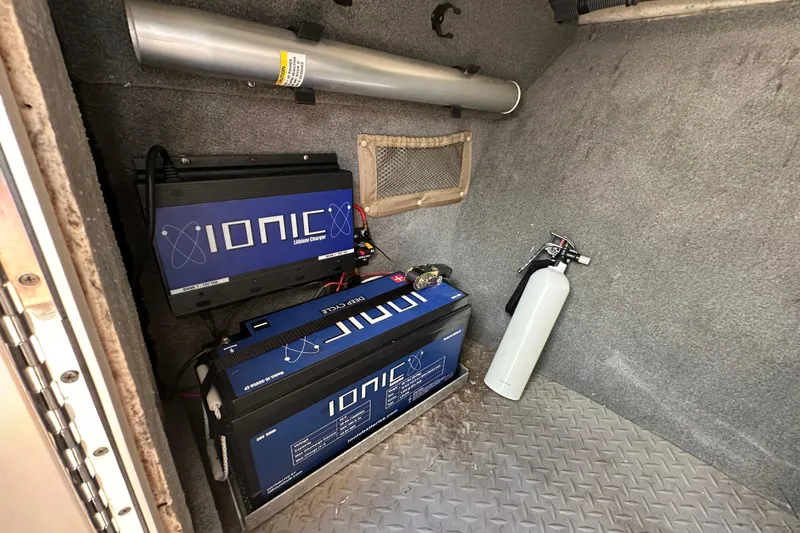 Slide: The Image of 2016 Grady-White Freedom 275 boat interior with white leather seating and steering controls. - 89