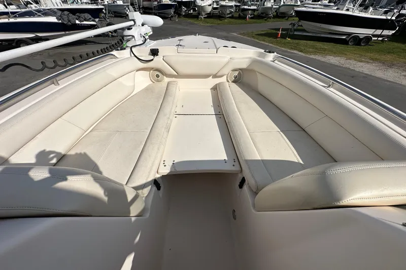 Slide: The Image of 2016 Grady-White Freedom 275 boat interior with cushioned seating and storage compartments. - 92
