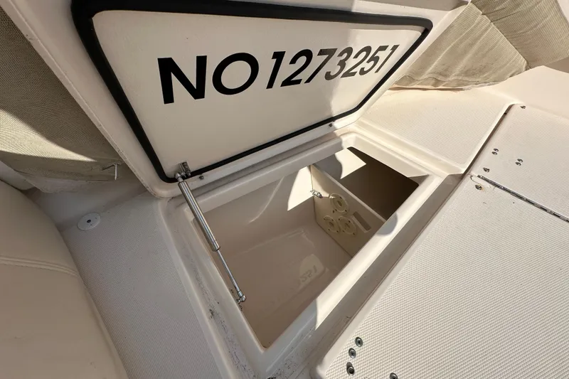 Slide: The Image of 2016 Grady-White Freedom 275 boat interior with seating and storage compartments. - 96