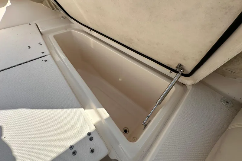 Slide: The Image of 2016 Grady-White Freedom 275 boat interior with seating and storage compartments. - 99