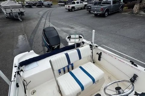 Slide: The Image of 2002 Seafox 195 Bay Fisher boat interior with seating and steering wheel, parked in a lot. - 9