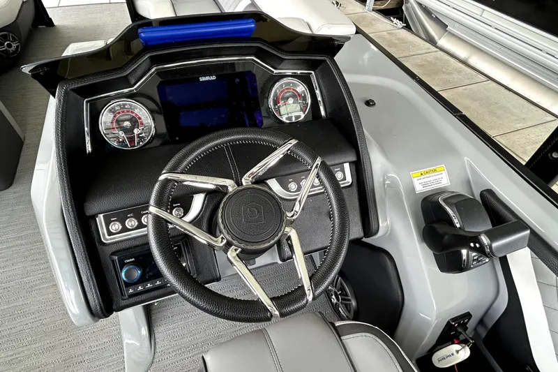 Slide: The Image of 2025 Godfrey AquaPatio 255 SDC Slide boat deck at marina, featuring sleek design. - 19